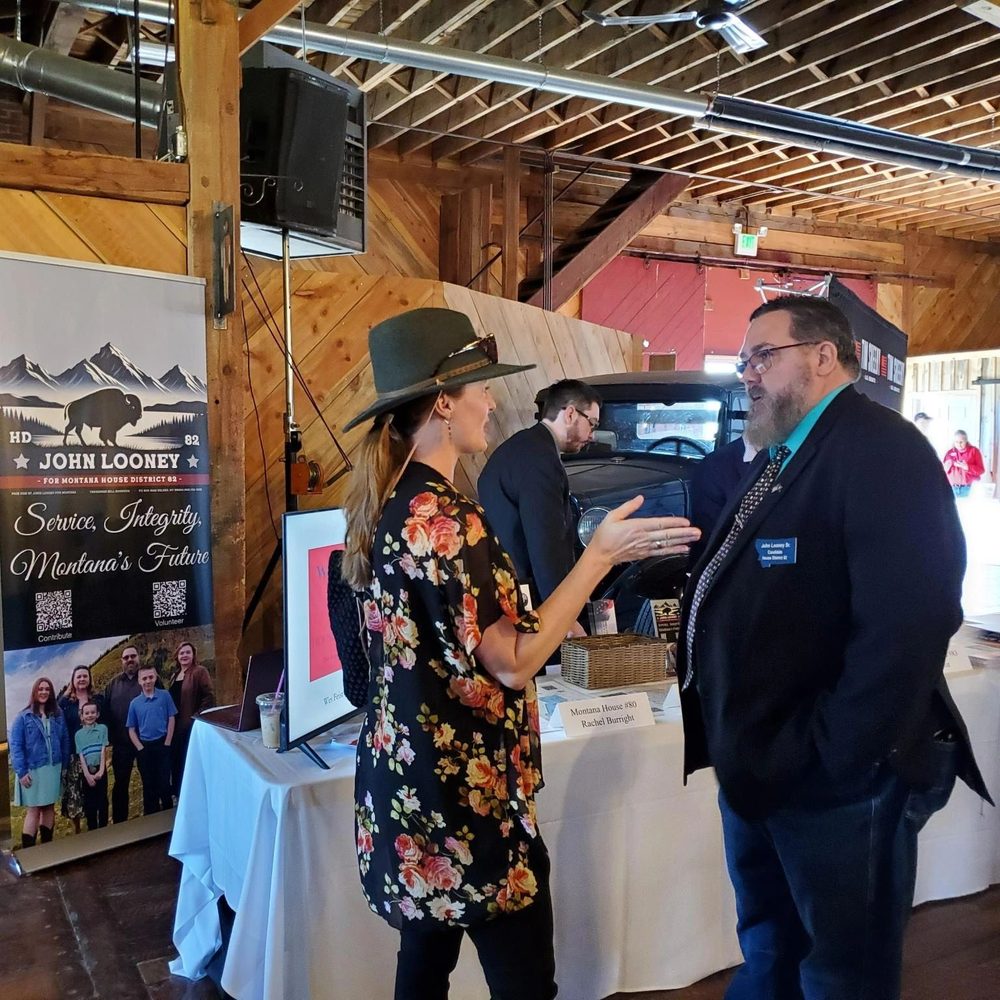 John Looney talking with a voter at a campaign booth