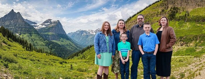 John Looney and his family in front of Montana mountains